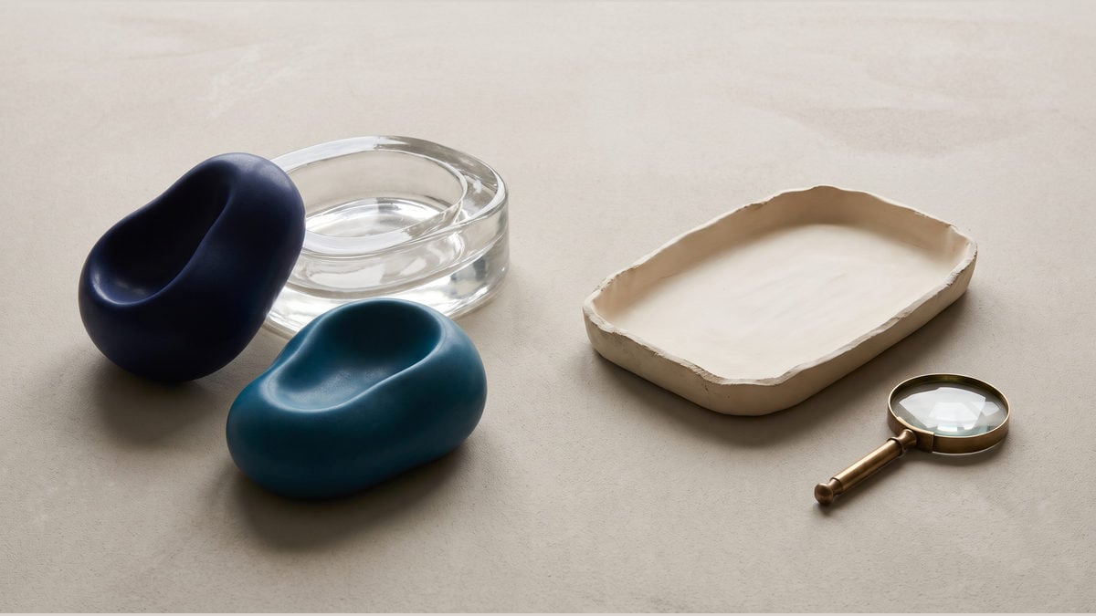 Two coloured forms beside a glass mould, tray and magnifying lens, illustrating a bounded replay check